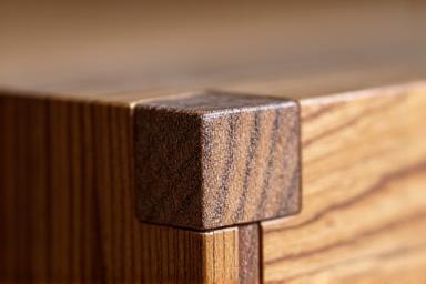 Close-up of a beautifully joined wood piece, showcasing fine craftsmanship.